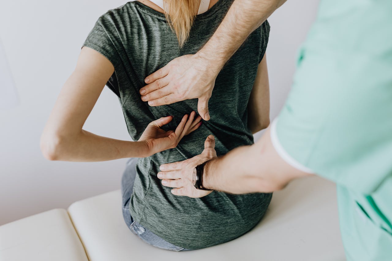A chiropractor examining a patients back to alleviate pain and discomfort.
